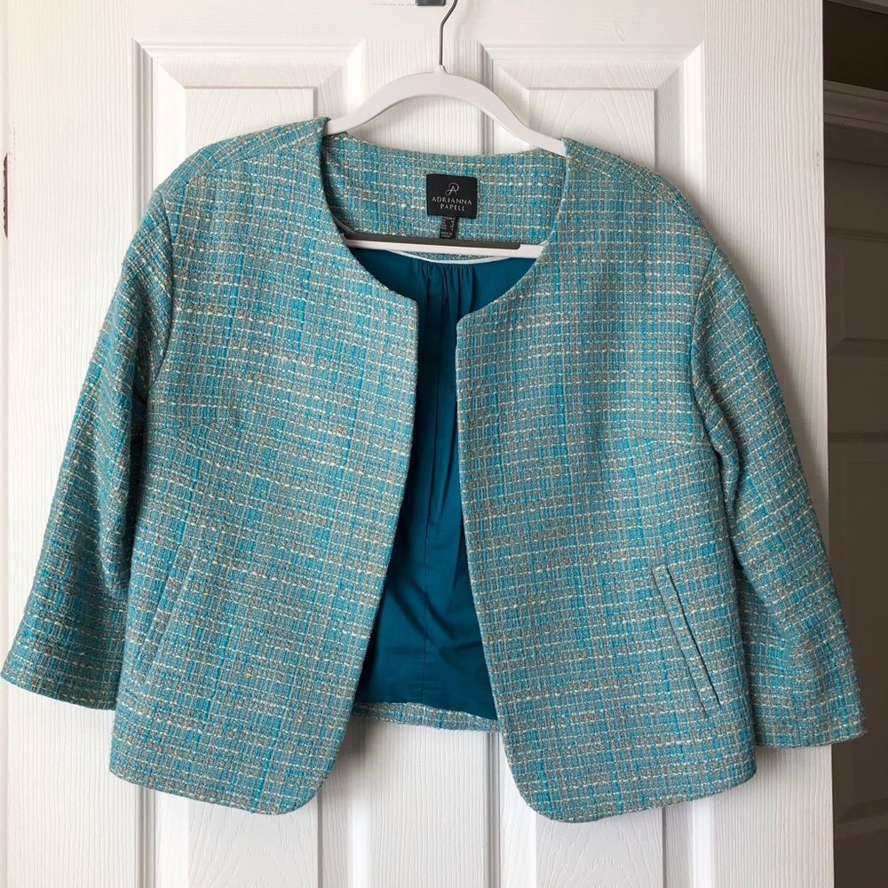 Waist length blue blazer.